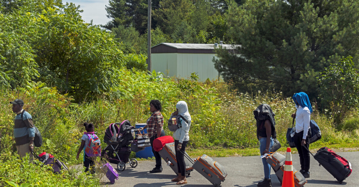 Asylum seekers preparing to cross the US-Canadian border from the end of Roxham Road in the town of Champlain NY