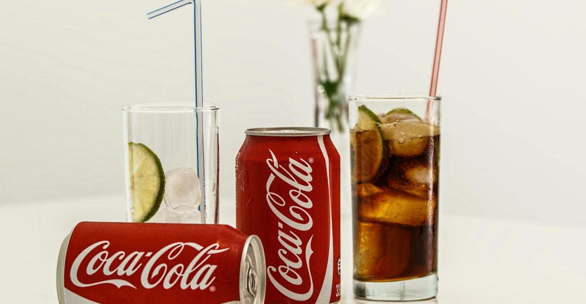 Coca-Cola cans with ice and lime on a table fresh and invigorating