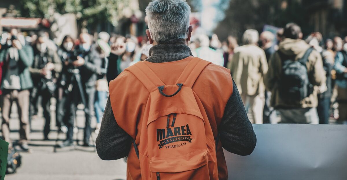 man backpack protest person bag back dissent demonstration regularization manifestation political street outdoors barcelona