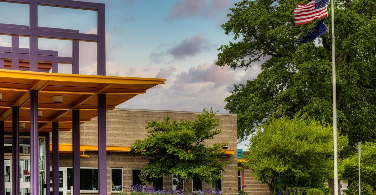 school nature building entrance trees grass american flag