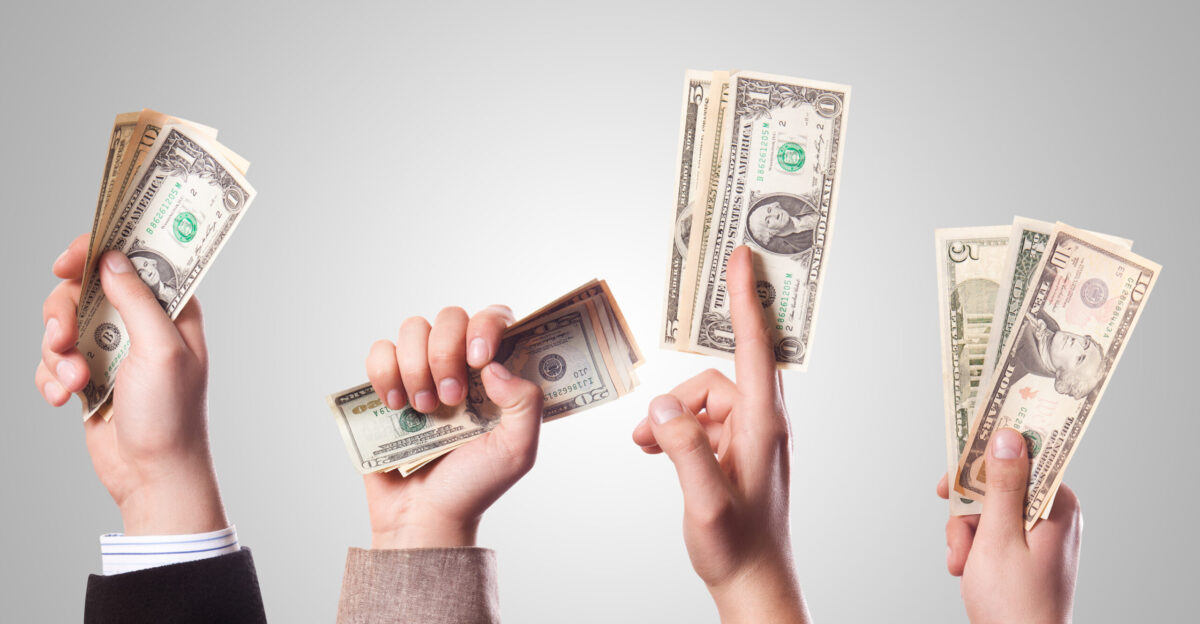 Four people holding money