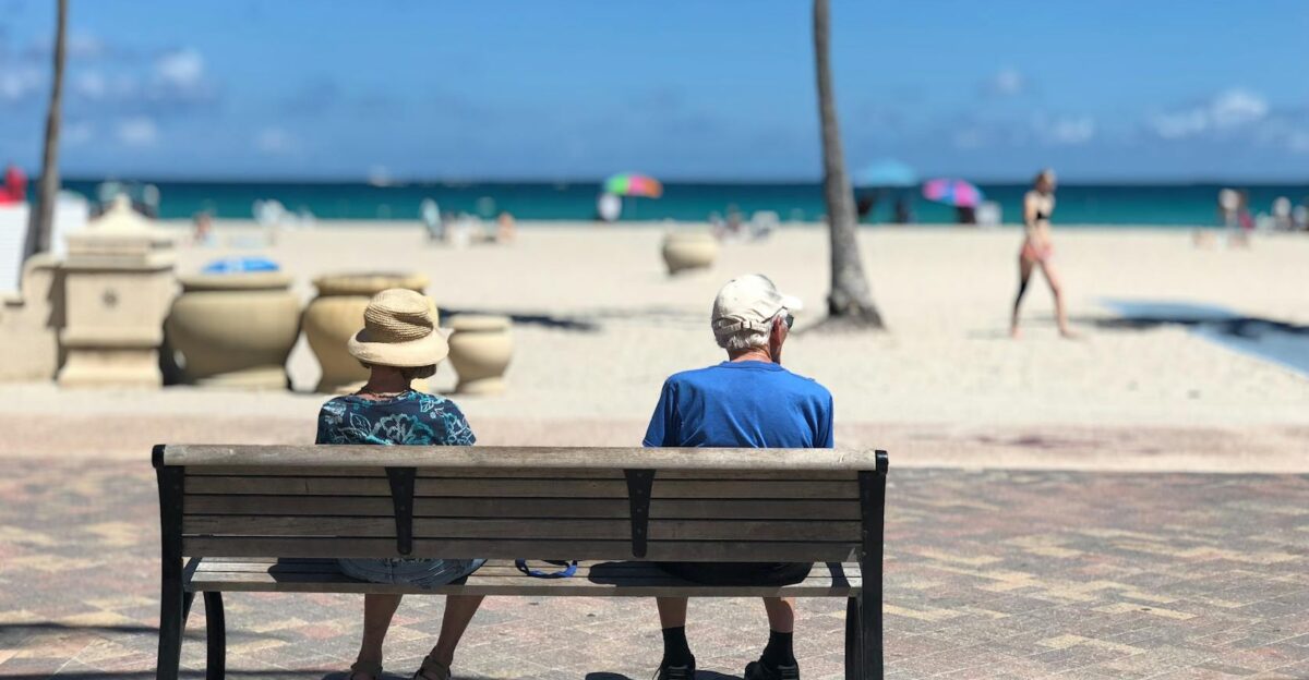 Senior couple sitting on a bench enjoying a sunny day at Hollywood Beach Florida