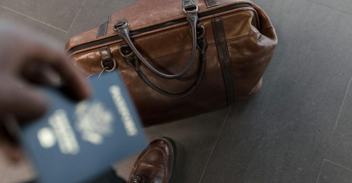 Brown leather bag with passport in an airport setting ideal for travel and fashion themes