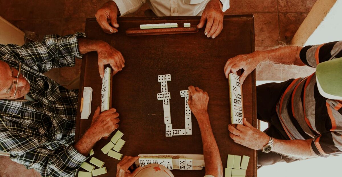 Senior adults playing dominoes indoors capturing the fun and companionship of game time together