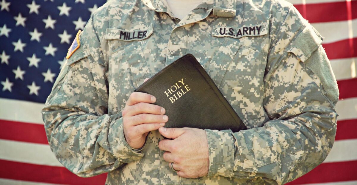 American soldier in uniform holding the Holy Bible symbolizing faith and patriotism