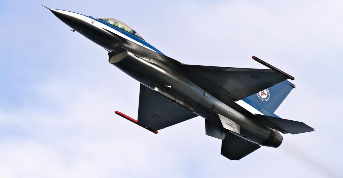 Military jet aircraft soaring through a clear blue sky showcasing advanced aerodynamic design