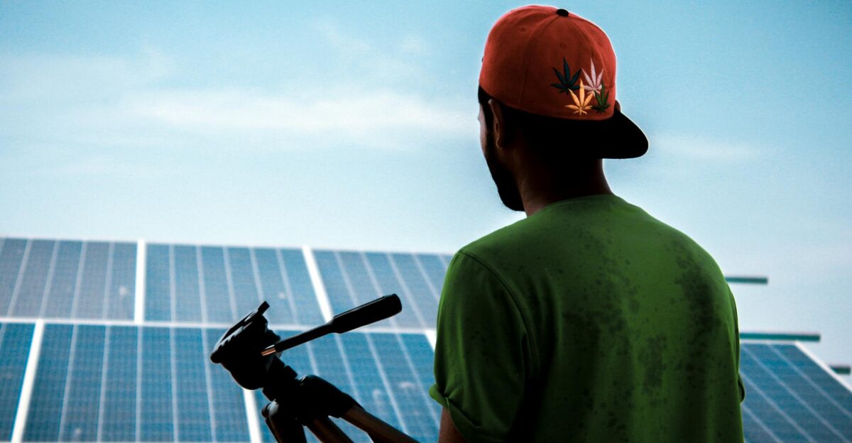 A person in a cap films a solar panel installation promoting sustainable energy solutions