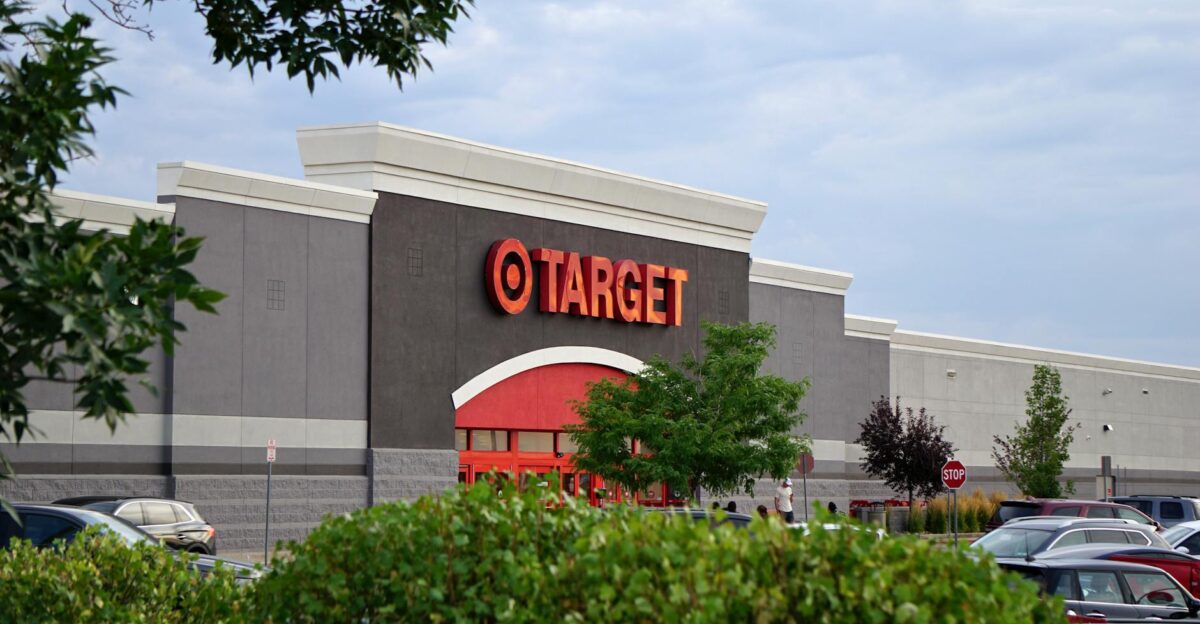 View of a Target store with parking lot featuring signage and greenery