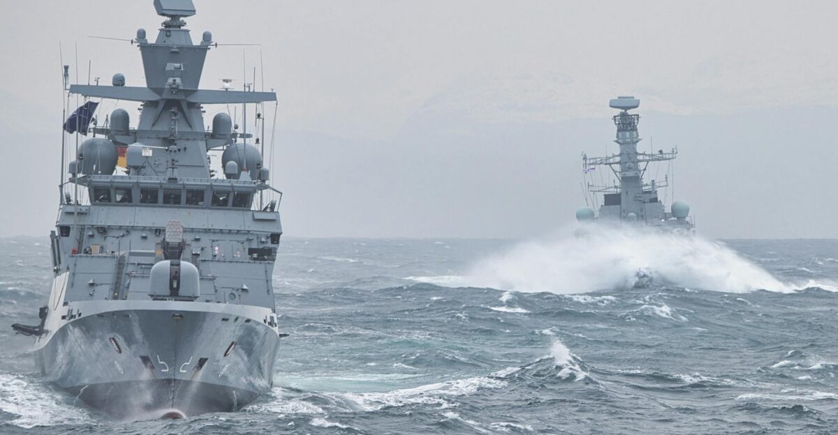 Navy warships navigating turbulent ocean waters showcasing maritime strength