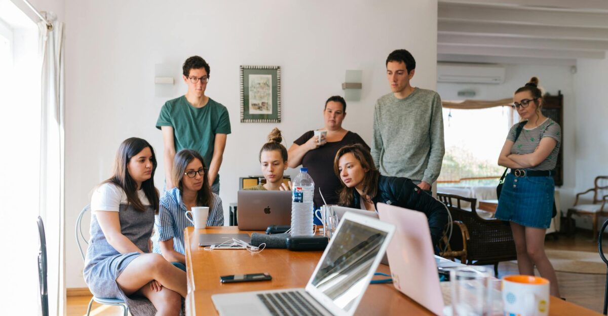 Group of young professionals engaged in a collaborative meeting in a modern office setting