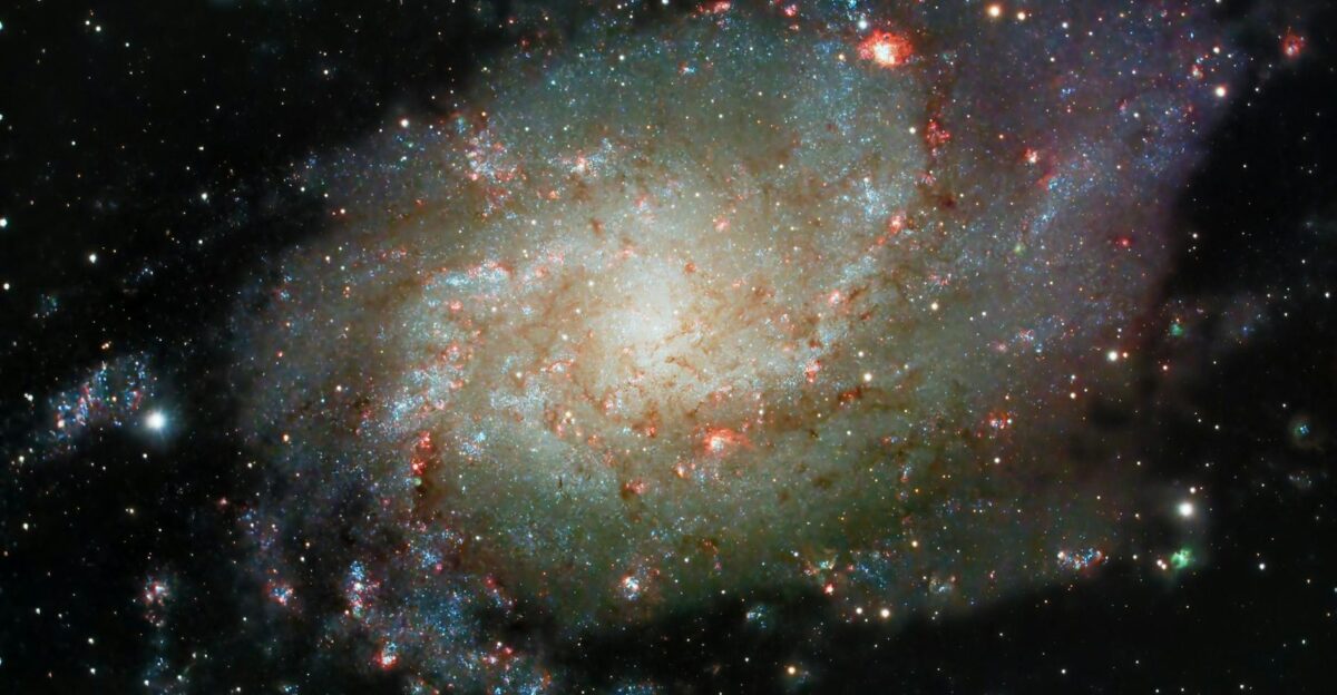 Explore the majestic spiral galaxy M33 with its vibrant cosmic colors an astronomical wonder in the night sky