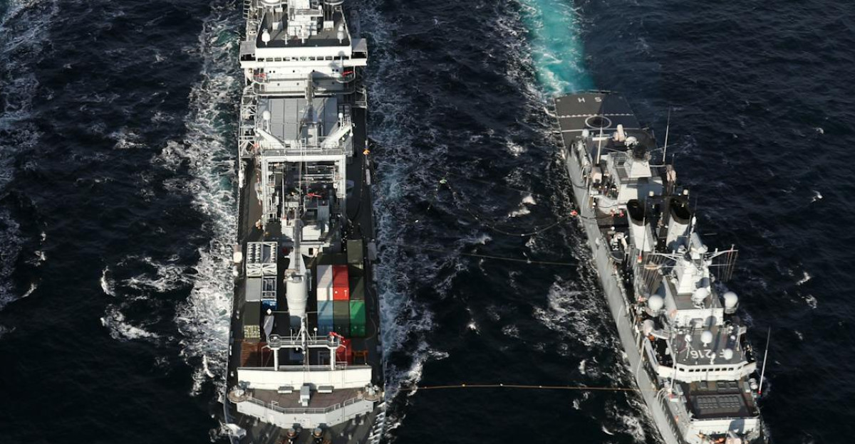 Naval ships sailing in formation on open sea aerial view highlights naval coordination and strategy