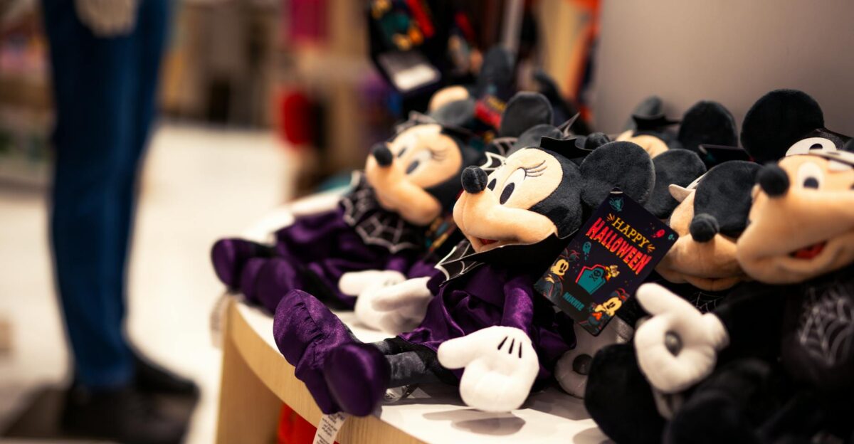 Close-up of Halloween-themed Minnie Mouse plush toys in a store setting perfect for festive decor