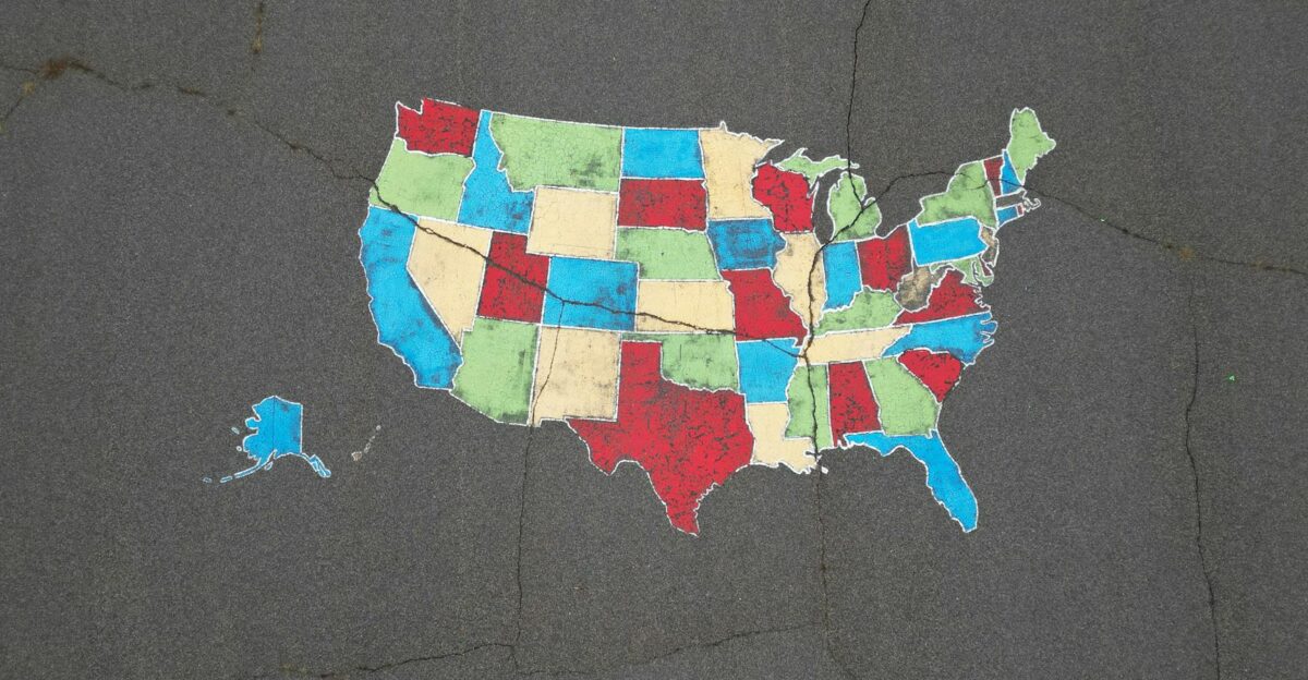 Vibrant map of the USA painted on pavement showcasing bold state colors