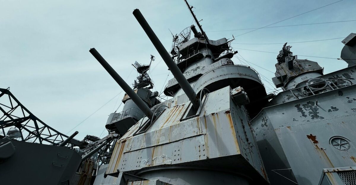 Close-up view of USS Alabama battleship s deck and cannons under a clear sky