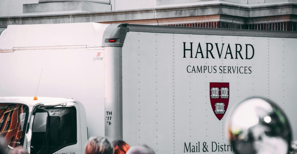 Harvard Campus Services truck in city street showcasing delivery near university building