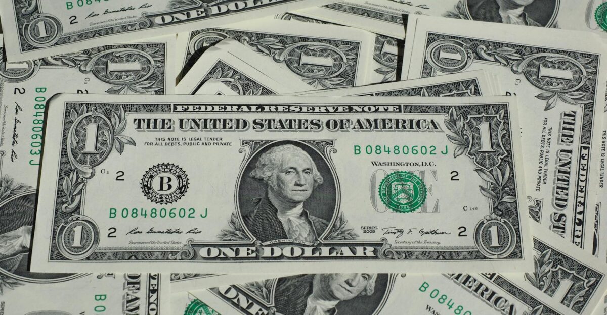 A detailed shot of a pile of U S one-dollar bills showcasing currency and finance concepts