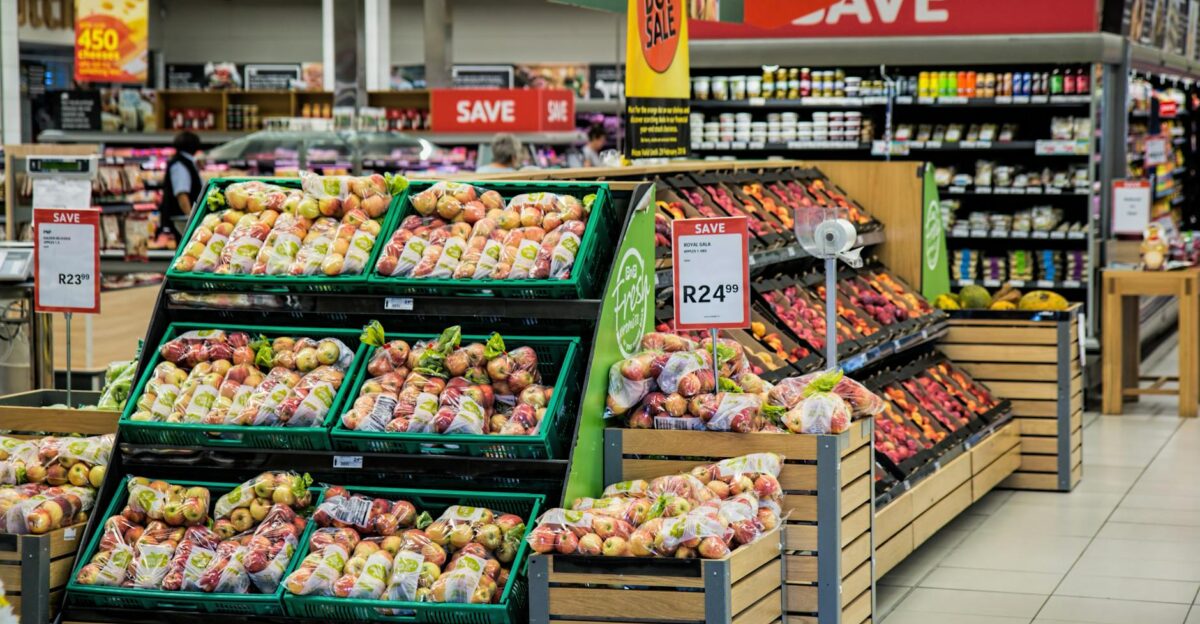 Colorful produce aisle in a supermarket showcasing fresh apples with discount signage