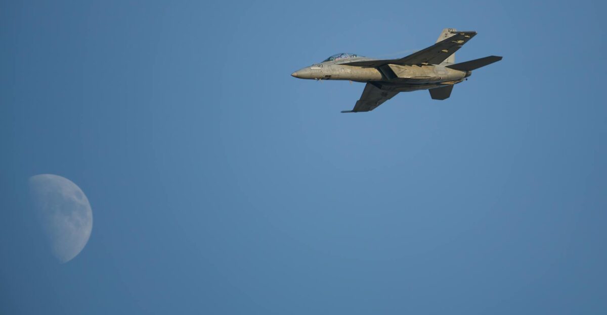 A military jet soaring through the sky with the moon in the background symbolizing speed and power