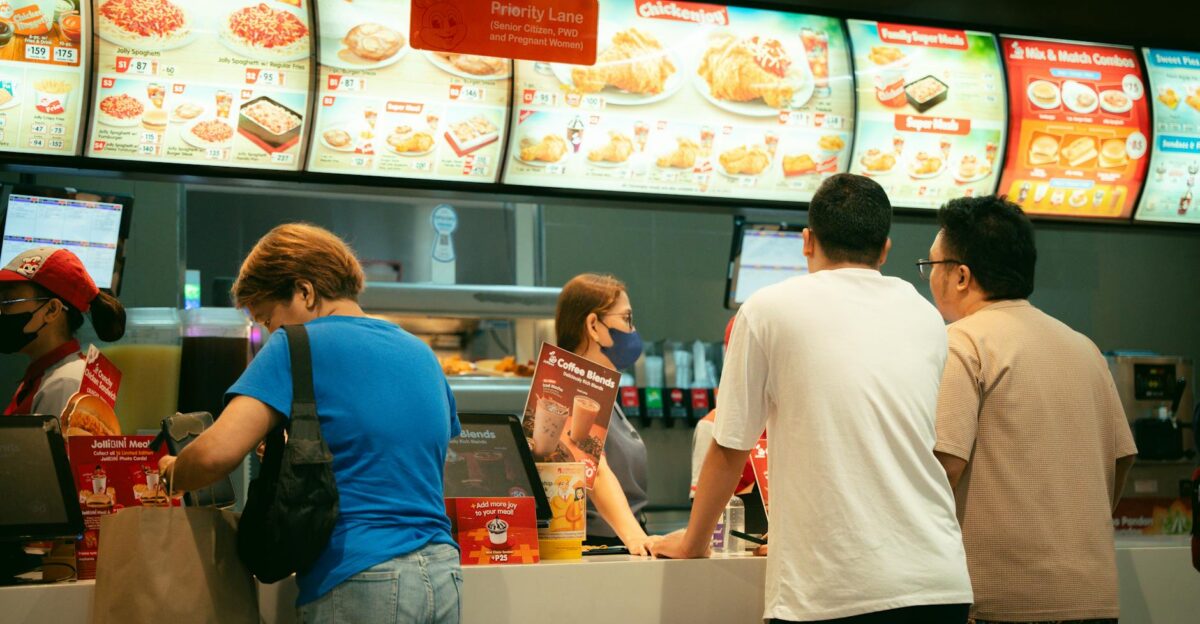 Customers ordering food at a fast food restaurant counter Busy atmosphere