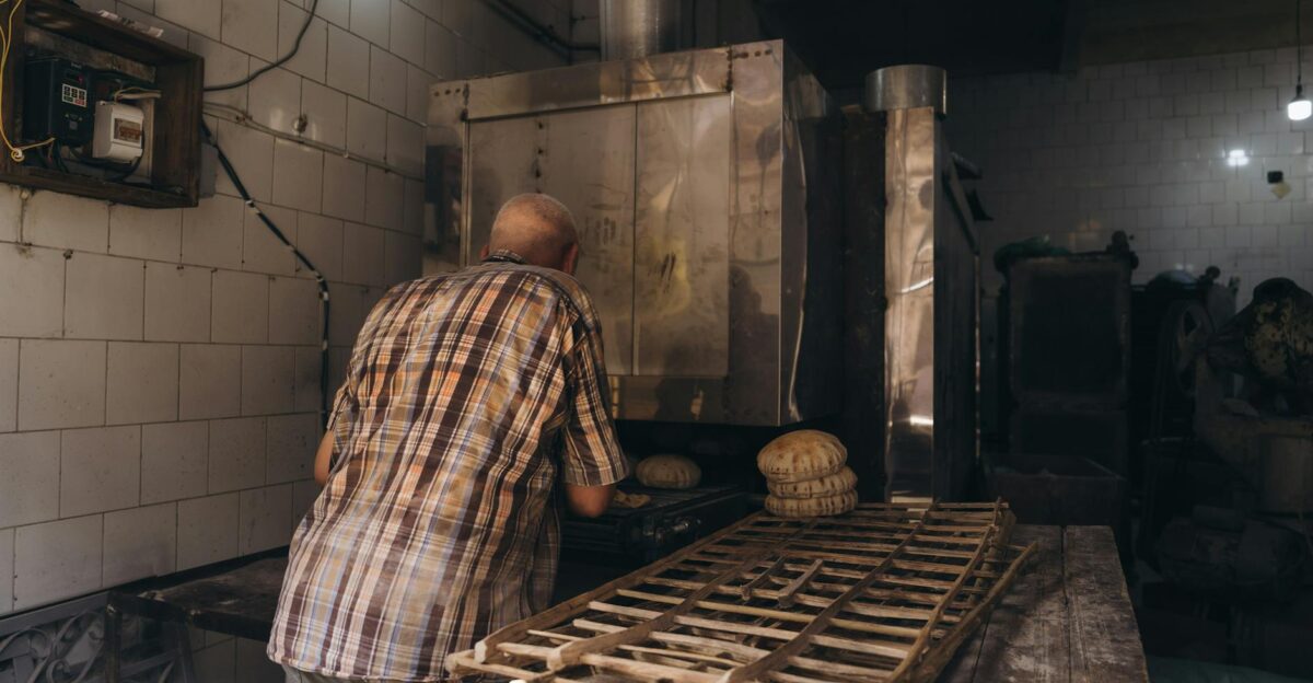 A man baking bread in a traditional bakery in Alexandria Egypt Rustic and cultural setting