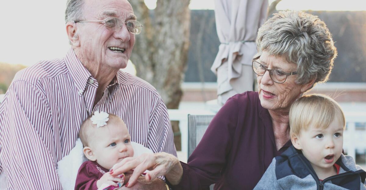 Grandparents spending joyful moments with their grandchildren in an outdoor setting captured candidly