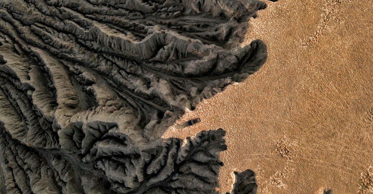 Drone capture of a barren eroded geological formation in a desert showcasing dramatic textures