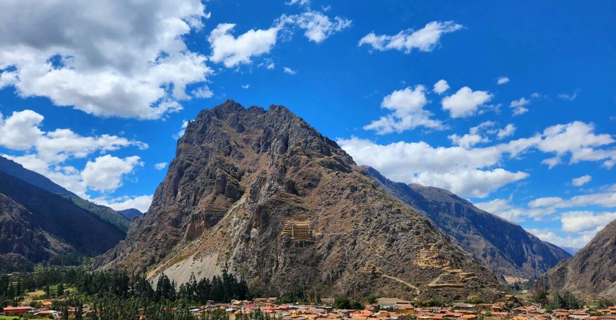 Beautiful view of Ollantaytambo village and Andes mountains under a blue sky