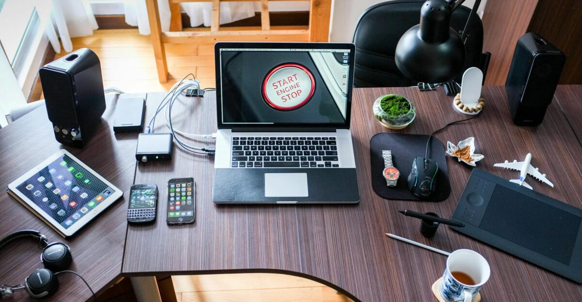 A contemporary office desk setup with laptops gadgets and accessories creating a tech-savvy workplace