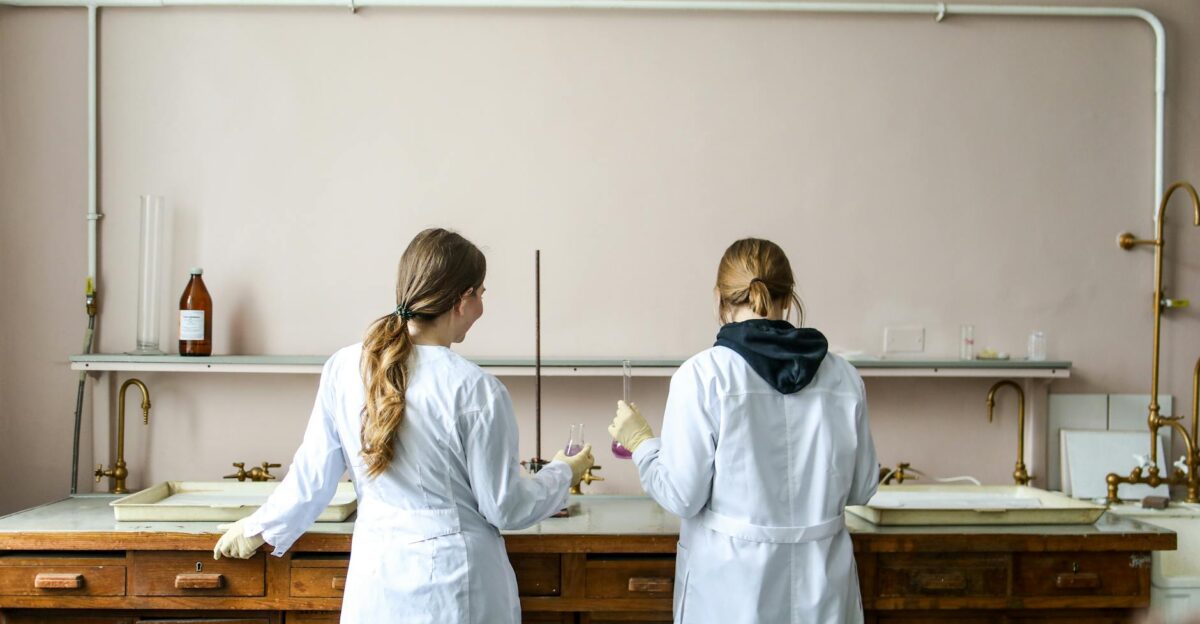 Two female scientists working on an experiment in a laboratory setting