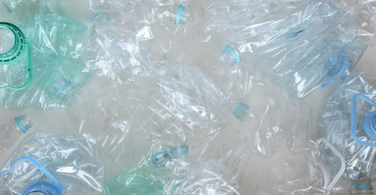 An overhead shot of crushed plastic bottles ready for recycling promoting eco-friendly practices