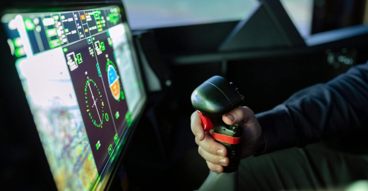 Close-up of a simulated aircraft cockpit with control joystick and digital display