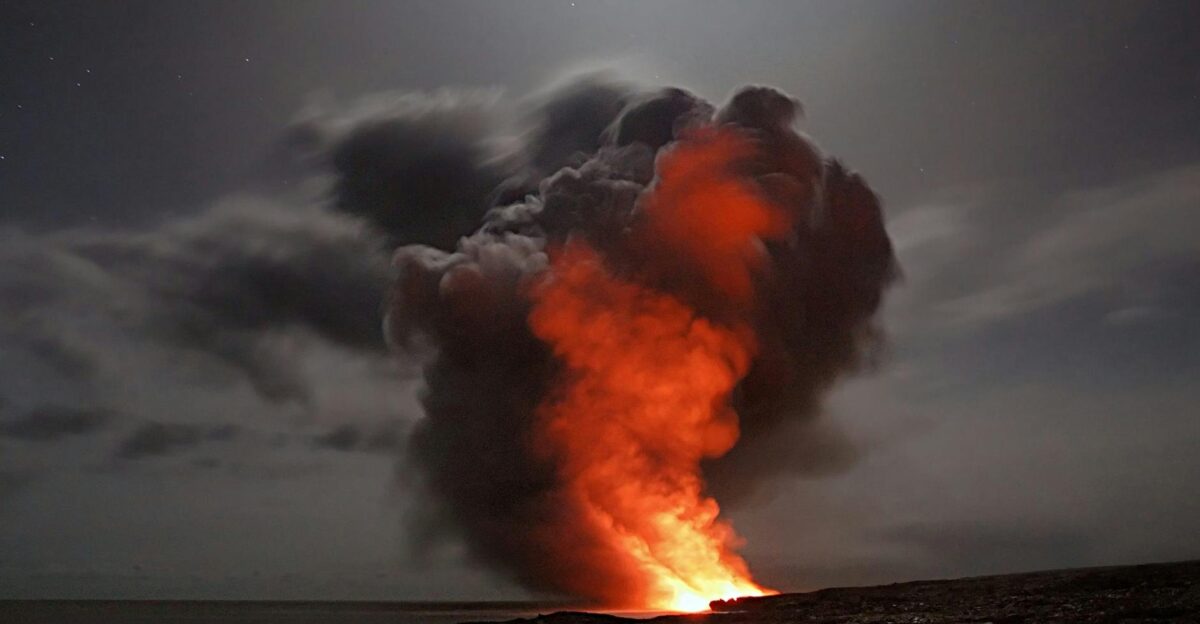 Volcanic eruption with smoke and lava under a starry night sky