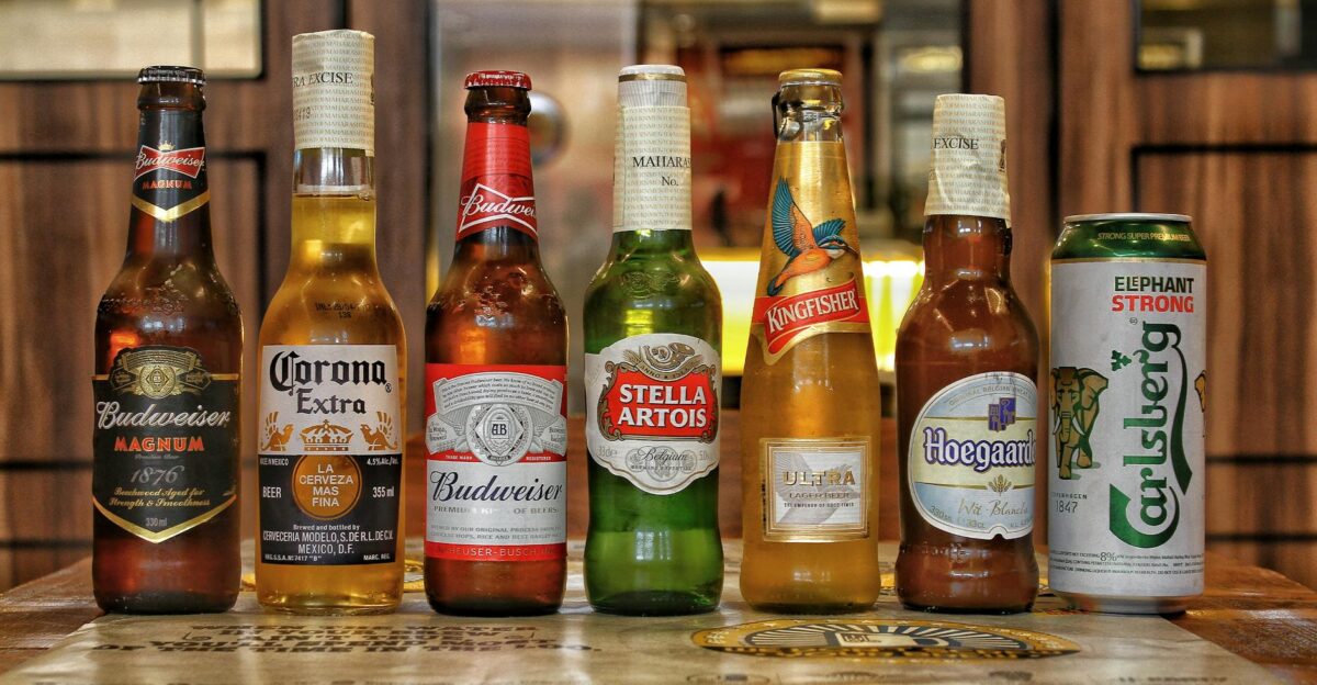 Collection of international beer bottles displayed on a bar counter