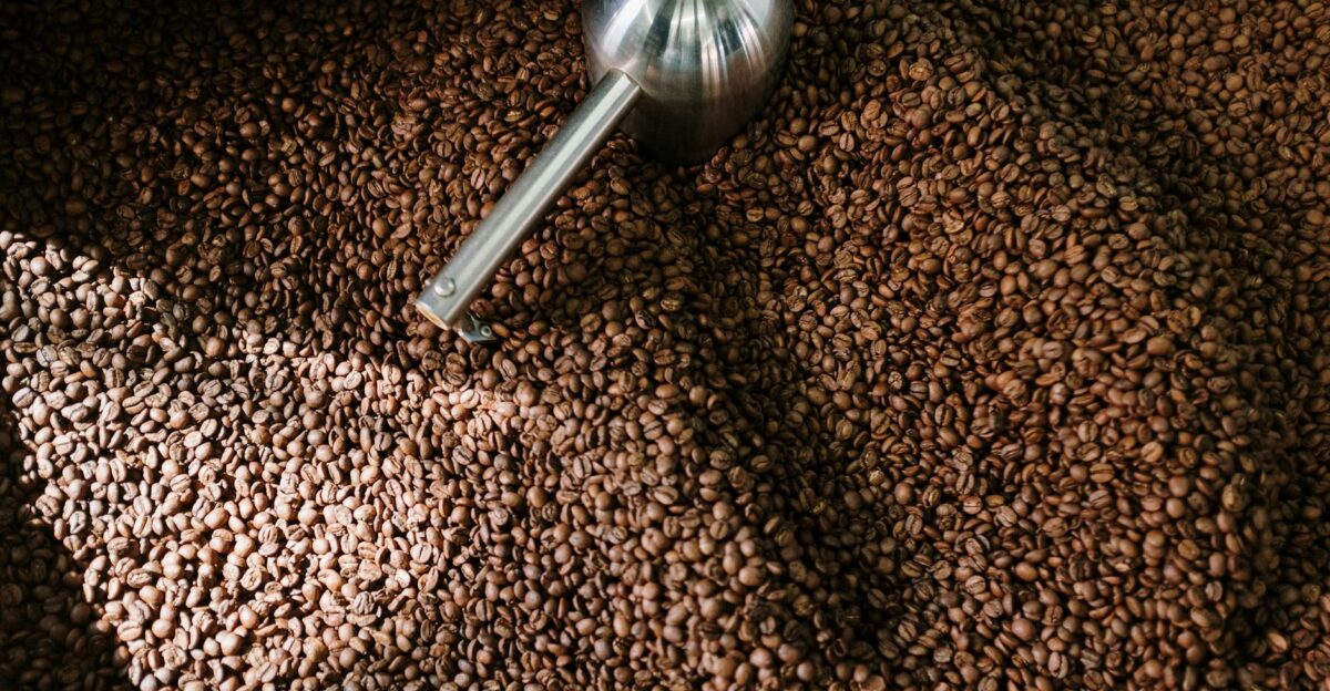 Detailed image of roasted coffee beans spinning inside a professional coffee roaster