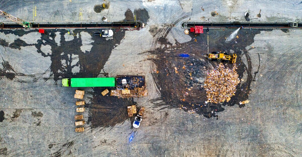 Aerial shot of waste processing site with heavy equipment and trucks in Serang Indonesia