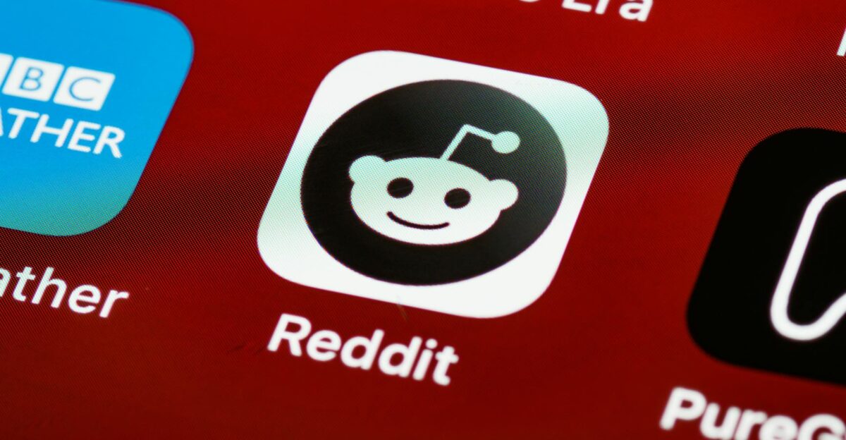 Detailed view of the Reddit app icon on a smartphone screen displaying popular applications