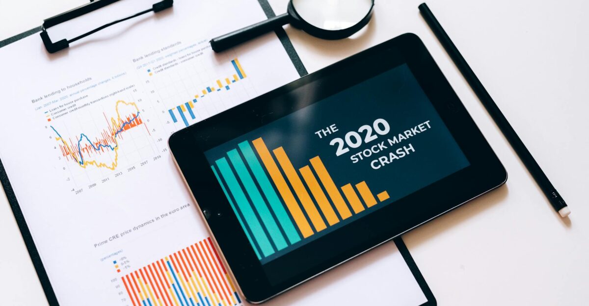 Close-up of financial graphs and digital tablet highlighting 2020 stock market crash