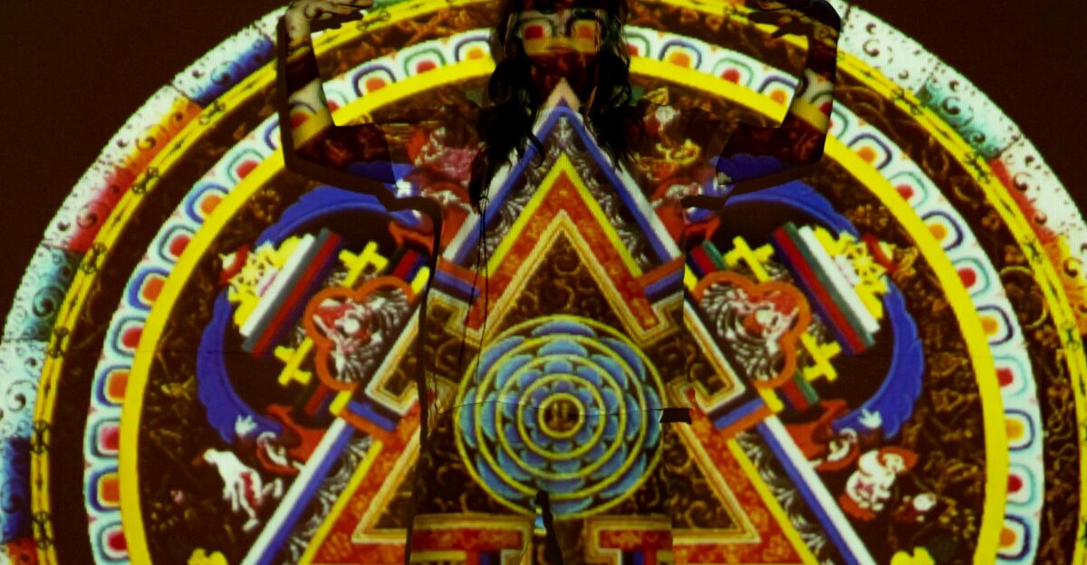 Vibrant psychedelic projection art on a woman with intricate mandala patterns