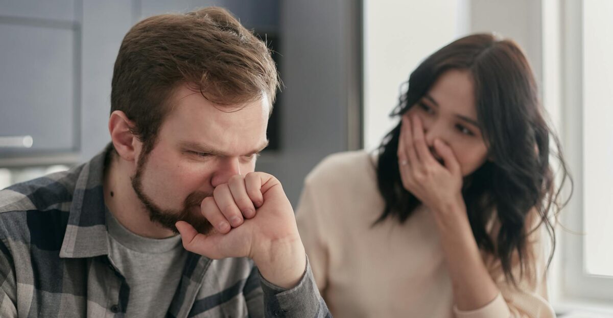 A couple looks anxious and distressed while having a serious conversation indoors