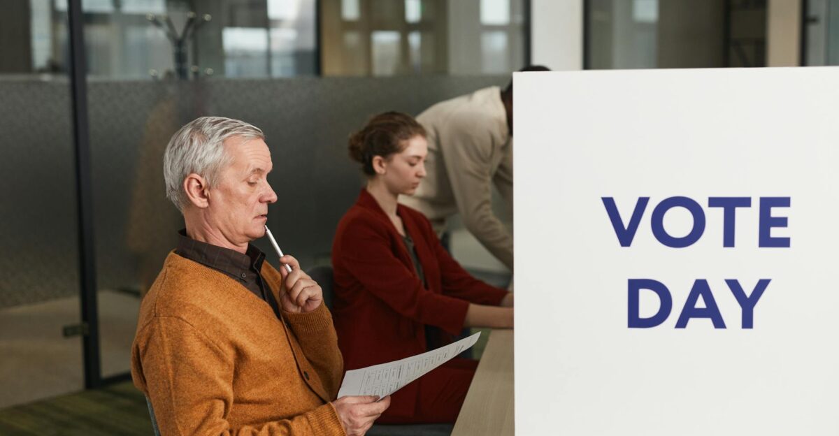 People voting indoors on election day making decisions at a polling station