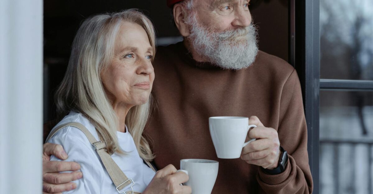 A senior couple embraces while enjoying coffee symbolizing love and companionship