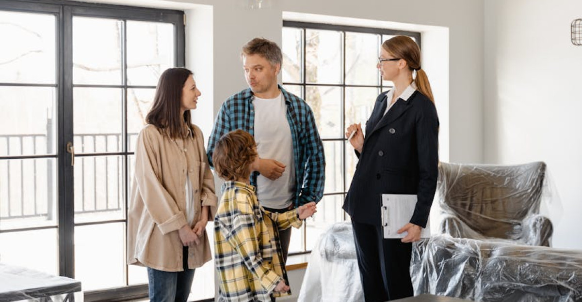 Family explores a new home with a realtor discussing the property details