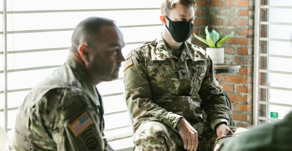 Two military personnel in a therapy session focused on mental health support and recovery