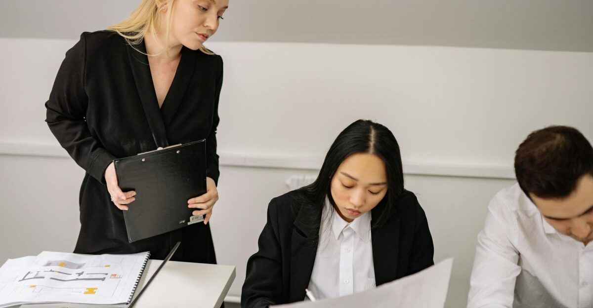 A diverse group of professionals engaged in a discussion during an office meeting