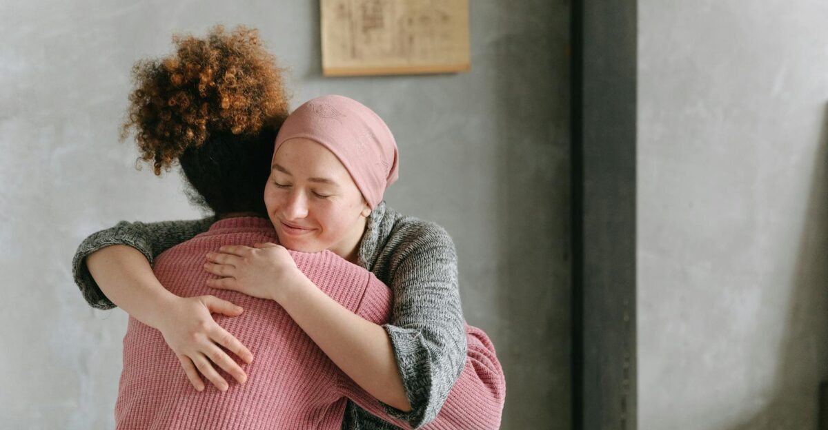 Two women embracing each other with warmth and love symbolizing support and care indoors