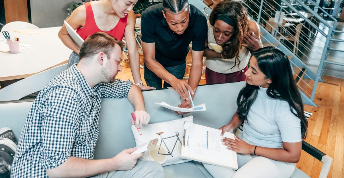 Dynamic group of colleagues brainstorming and working together in an office setting
