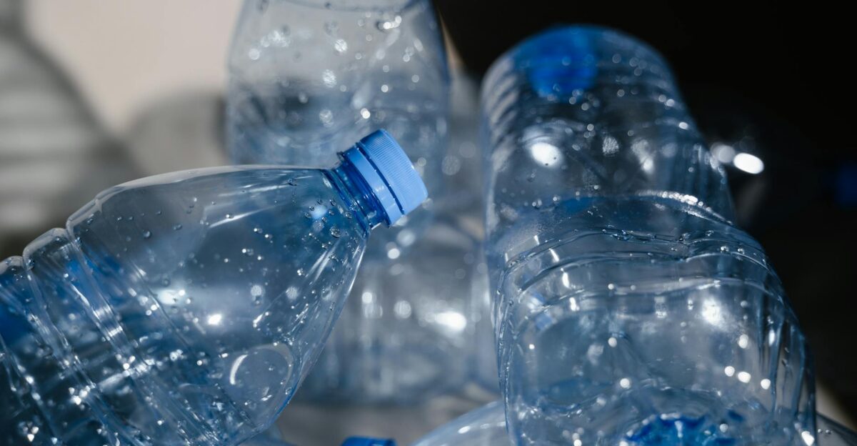 Multiple empty plastic bottles with water droplets in a close-up shot highlighting recycling