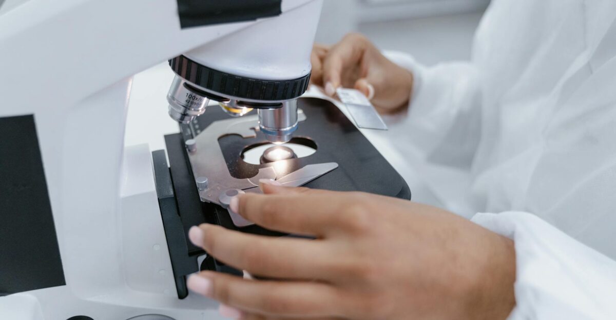 Scientist in laboratory using a microscope for detailed sample analysis