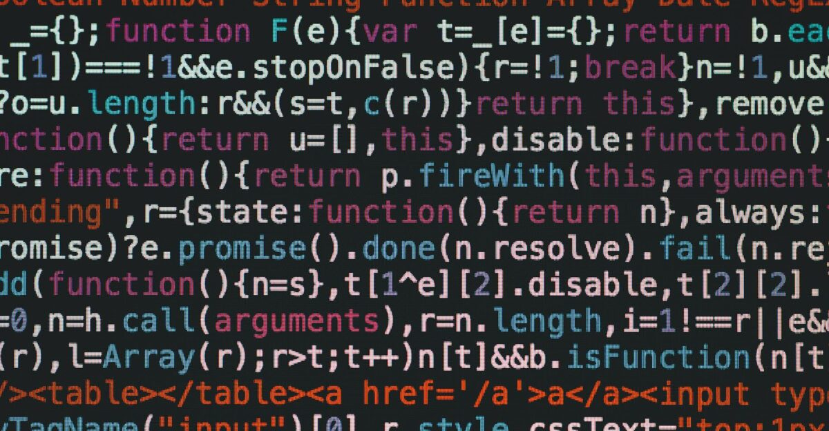 Close-up of colorful coding text on a dark computer screen representing software development
